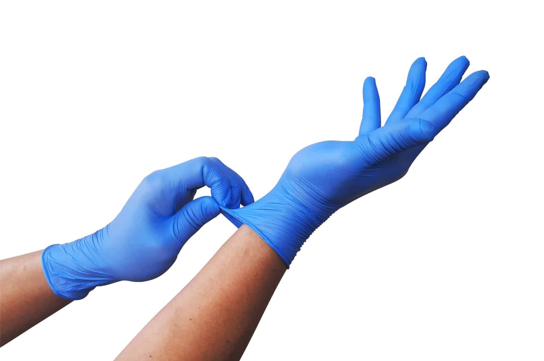 Hands wearing disposable blue nitrile gloves for comparison of vinyl vs nitrile
