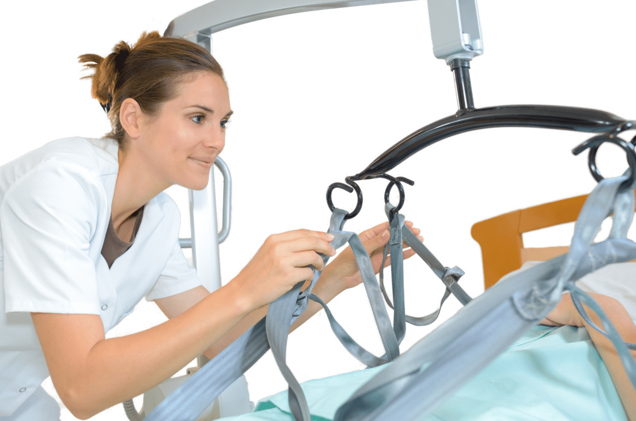 A nurse adjusts a sling on a recently LOLER tested patient lift sling attached to a bed, preparing to assist a patient.