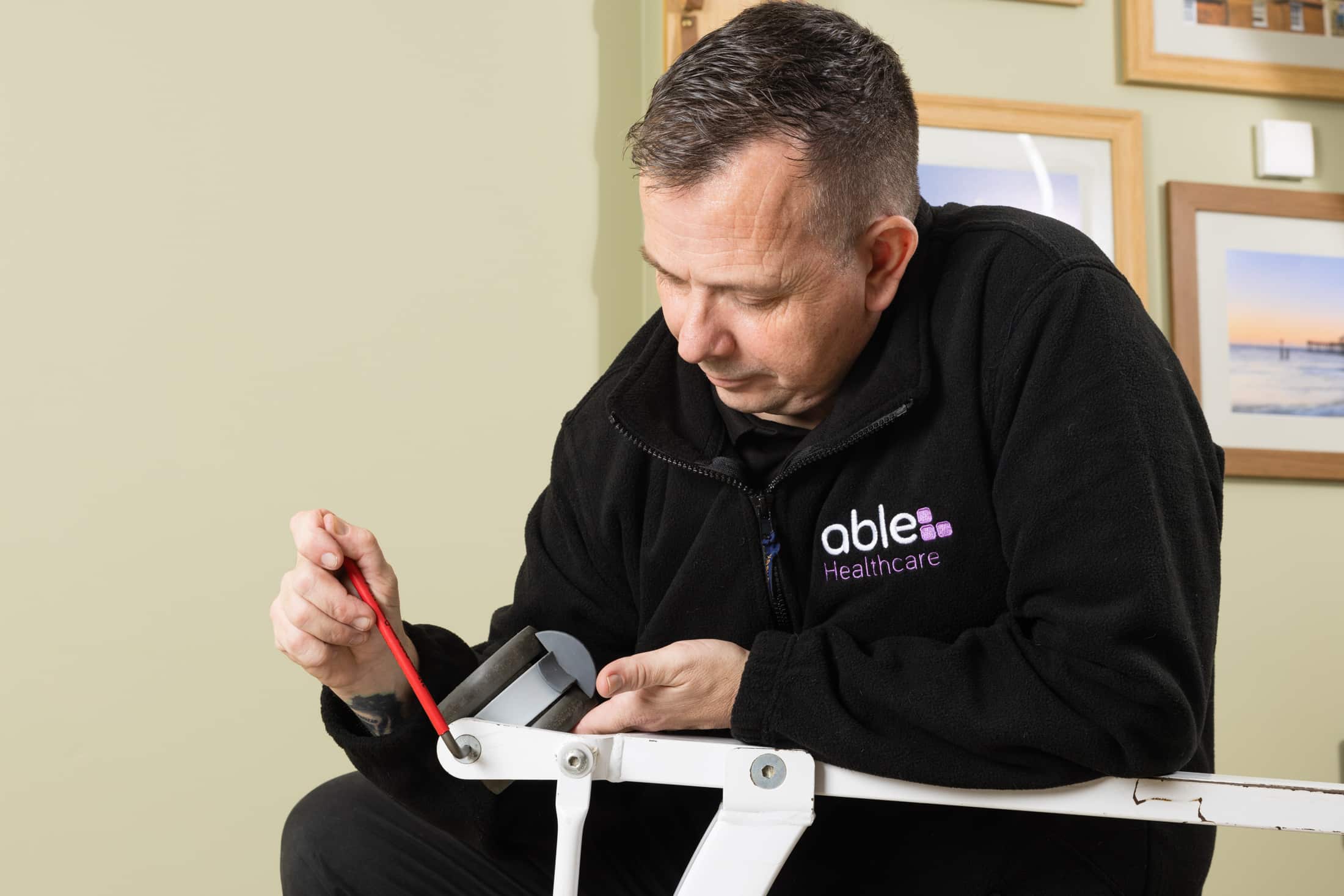 Able Healthcare engineer performing a LOLER inspection on care home equipment.