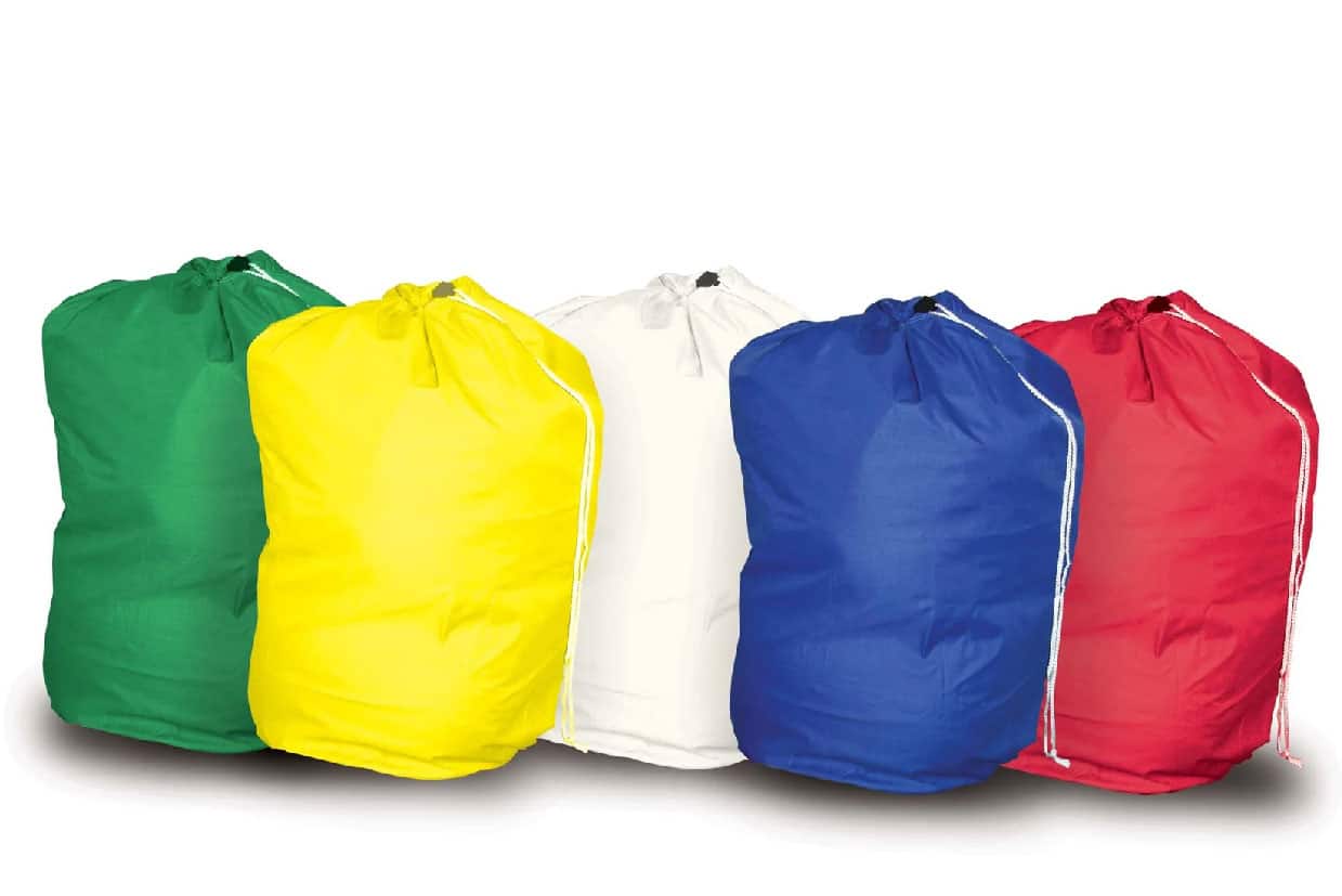 Colour-coded laundry bags for care home use, including red, blue, white, yellow, and green drawstring bags