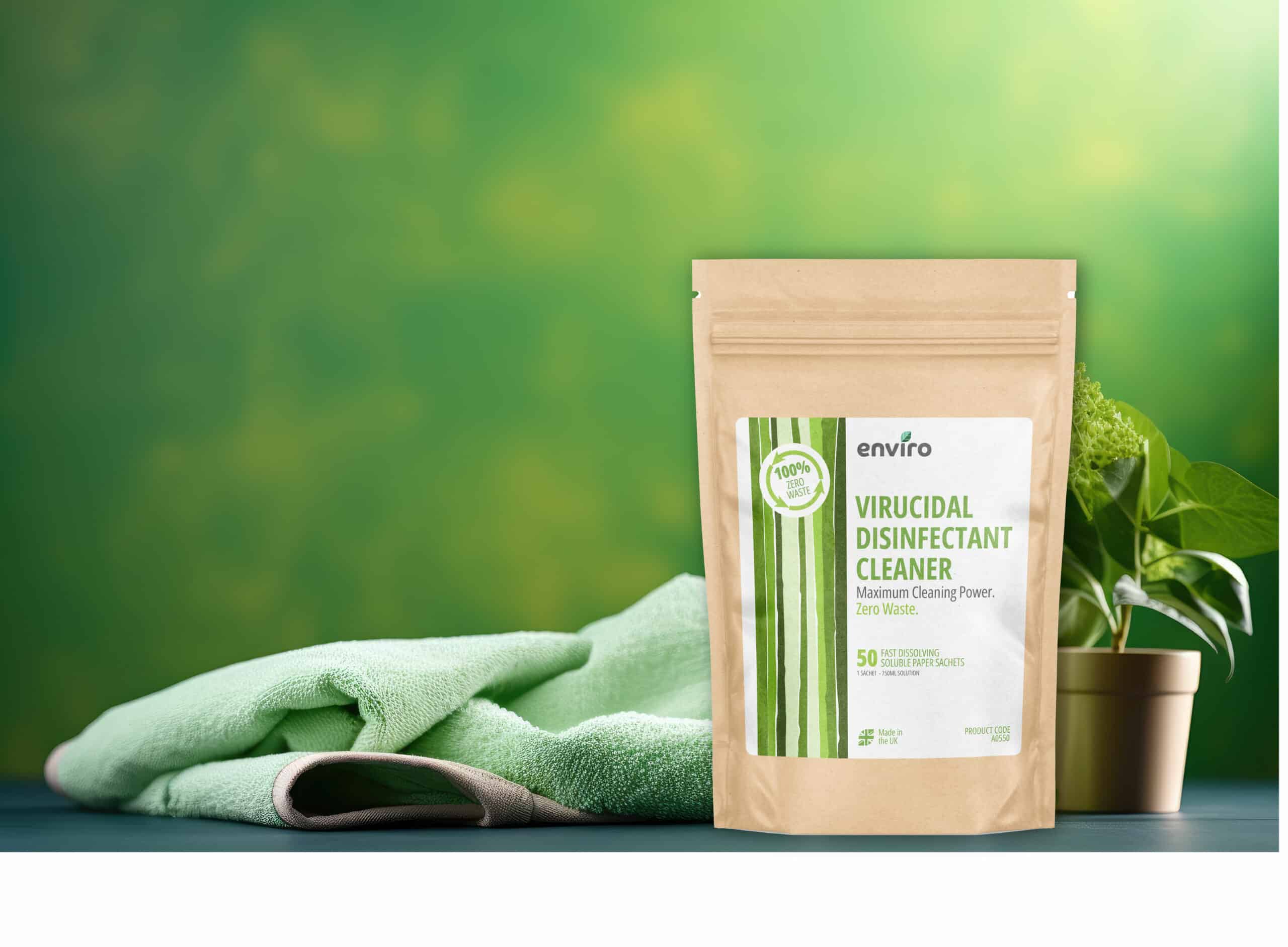 A brown paper pouch labeled "Virucidal Disinfectant Cleaner" is displayed next to a green cloth symbolising Eco Friendly Disinfectants