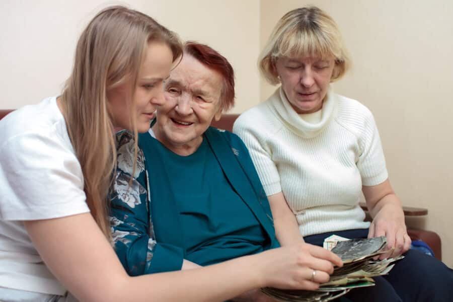 Care home resident sitting with family visitors during the Christmas period