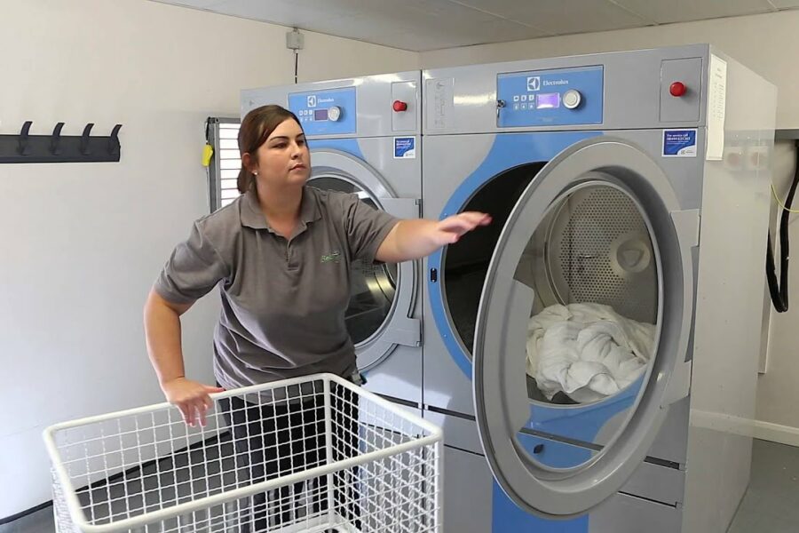 commercial laundry equipment cost shown through commercial machines in use