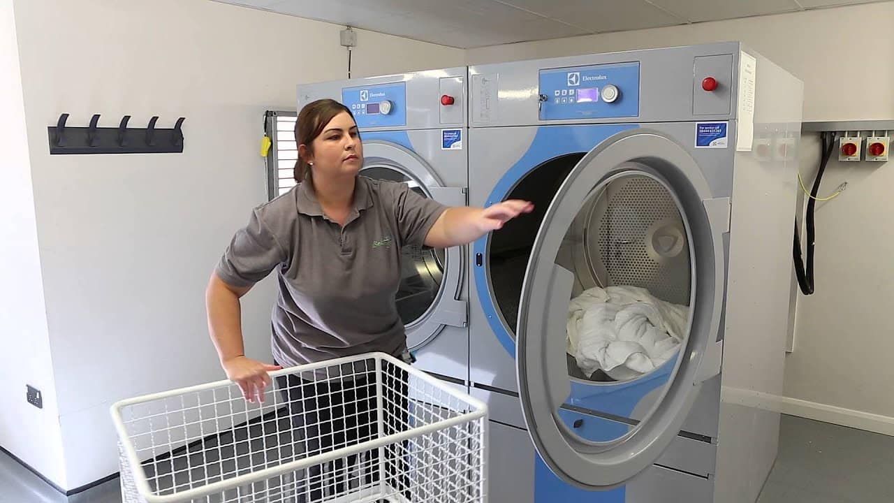 commercial laundry equipment cost shown through commercial machines in use